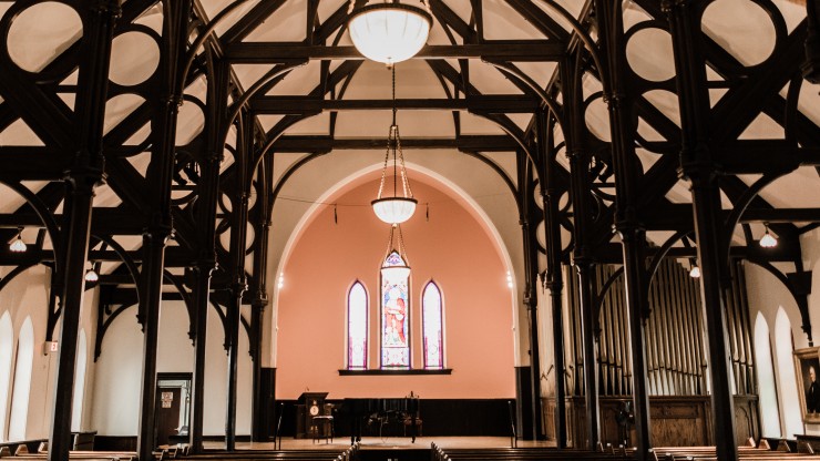 Marvin chapel during the daytime with sun shining through the stained glass windows