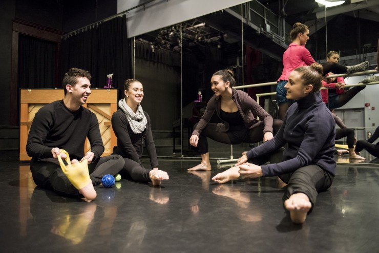 Dean College dancers stretching in a dance class