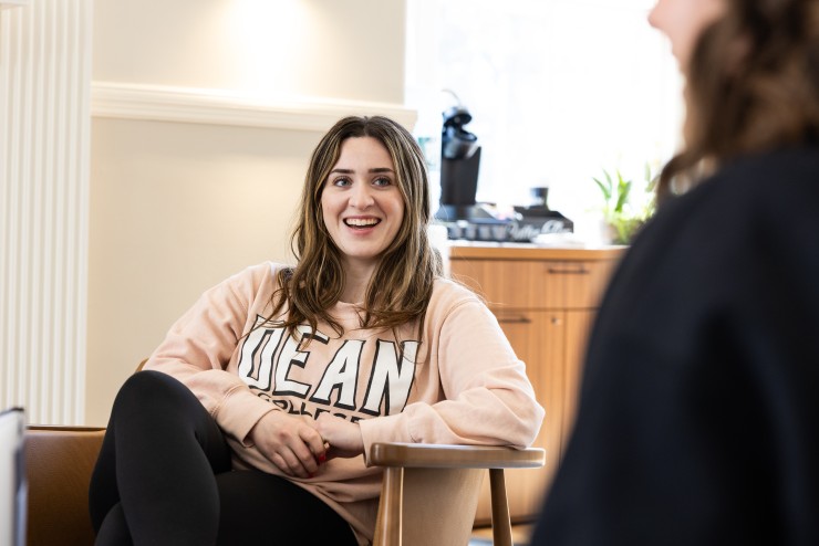 Young Woman Chatting with Friend in Student Center