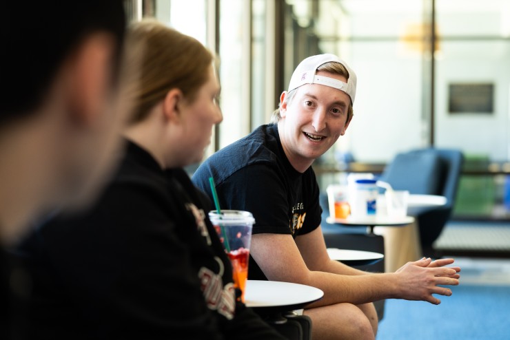 Student and Friends Chatting in Library