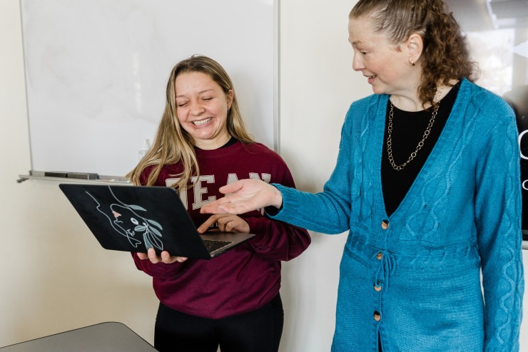 Dean College professor working with a student 