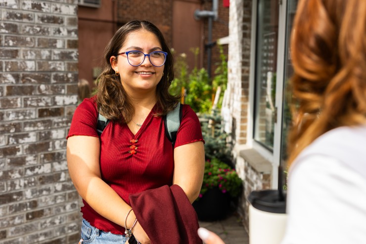 Students Standing Outside Coffee Shop Smiling