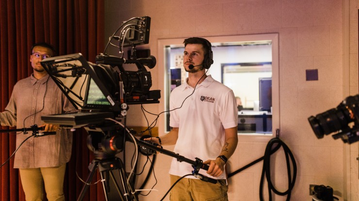 Communications major operating a video camera in the digital studios