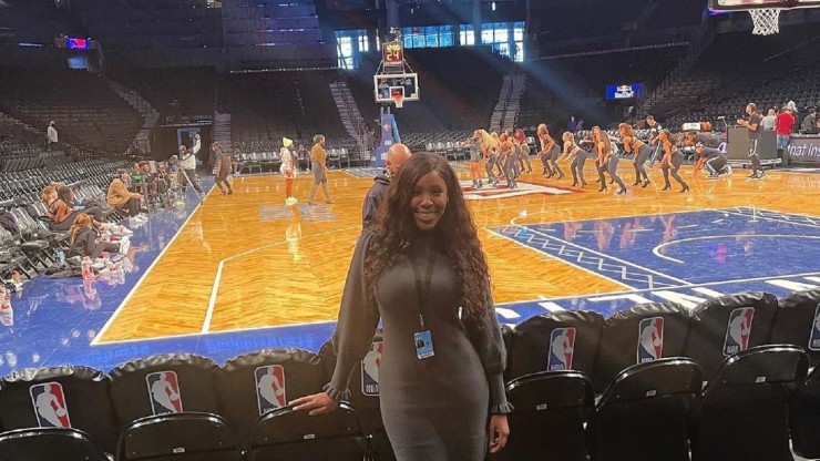 Student standing courtside at an NBA game