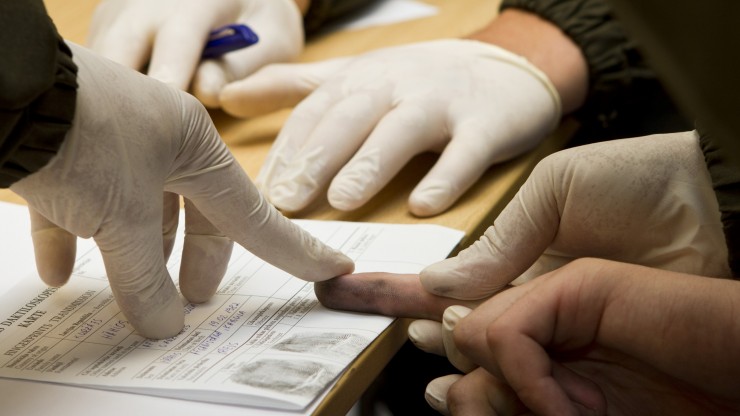 Students taking the fingerprints of another student during the Criminology: Theories of Crime course at Dean College.