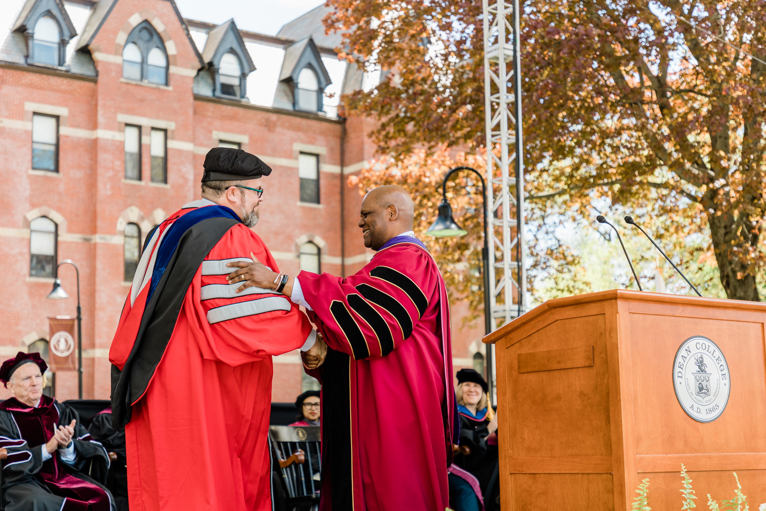 Dr. Dennis receiving award from President Elmore at Commencement